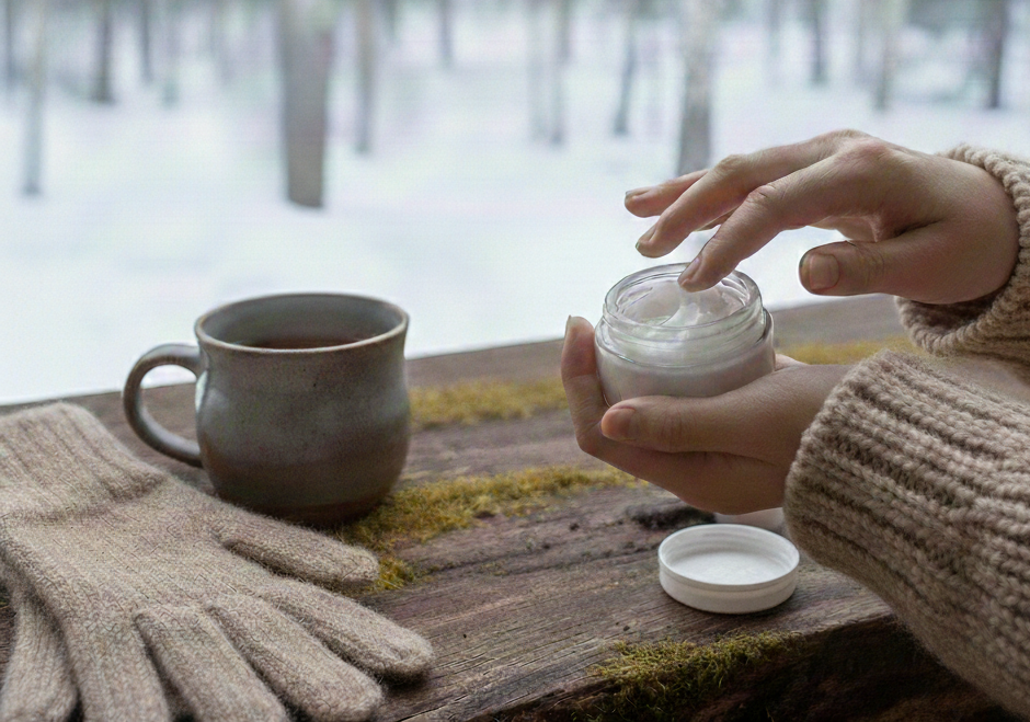 Péče o ekzematickou pokožku v zimě – ruce nanášející přírodní krém v chladném počasí